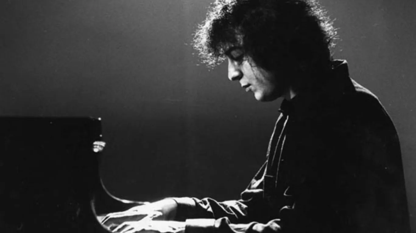 Nicolas Economou seated at a piano in Steve Sklair’s biographical documentary