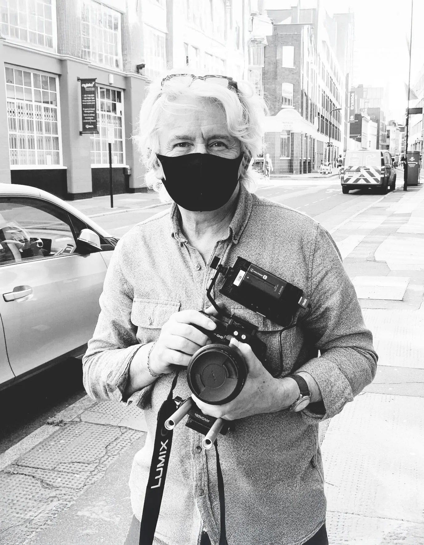 Documentary filmmaker Steve Sklair holding a camera on a London street